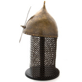 solid brass Indo-Persian fighting helmet is engraved, features brass mail aventail, and ornately embellished brass nasal bar 