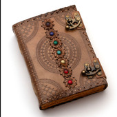 leather journal with 7 chakra stones surrounded by leather stitching, embossed mandalas, secures with 2 antiqued brass latches