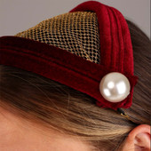 Juliet hat has gold netting trimmed with stiffened, dark red velvet, faux pearl buttons anchor each side