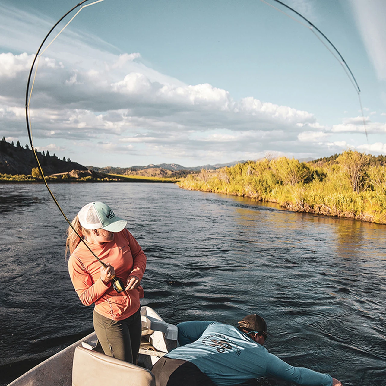 Angler fighting a fish on a Douglas SKY G from a drift boat