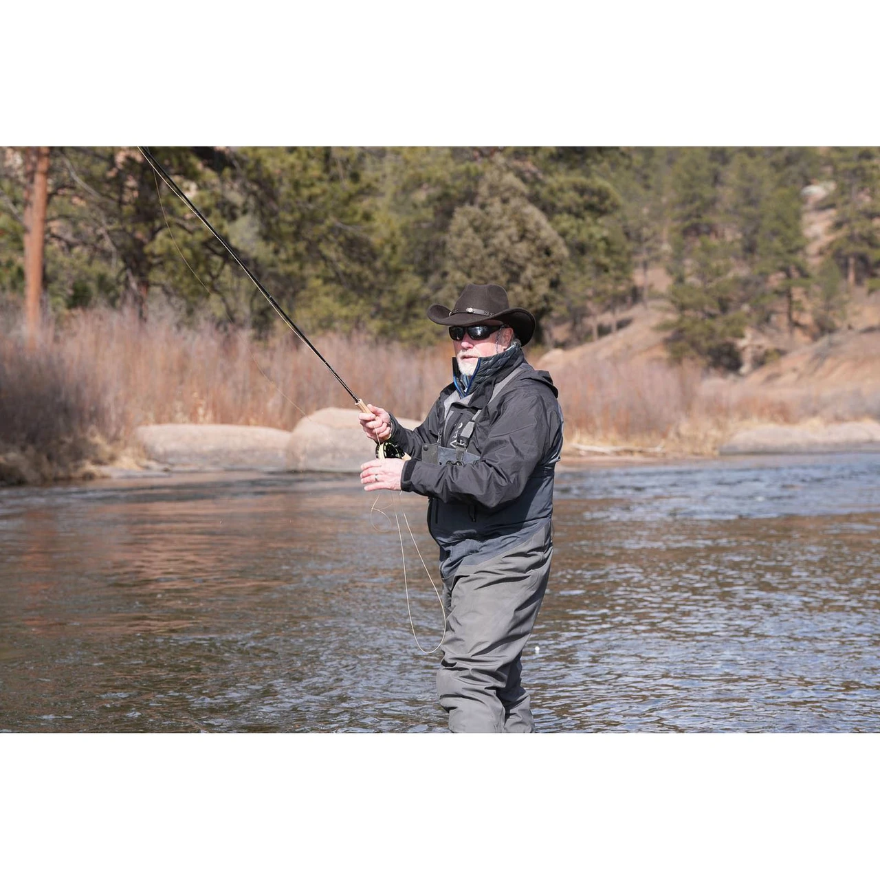 Angler fishing a Scott Session fly rod in a river