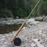 Douglas Upstream fly rod and reel on a rocky riverbank