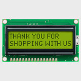 Front view of an unlit 16x2 character LCD with an STN+ yellow-green screen showing a thank you message in dark text.