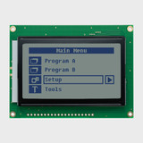 Vue de face d'un écran LCD graphique de 128 x 64 pixels affichant une interface de menu simple composée de pixels sombres sur un écran STN+ gris non éclairé.