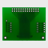 The back of a green circuit board with 2x13 thru-hole connection points.