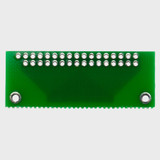 The back of a green circuit board with thru-hole connection points.