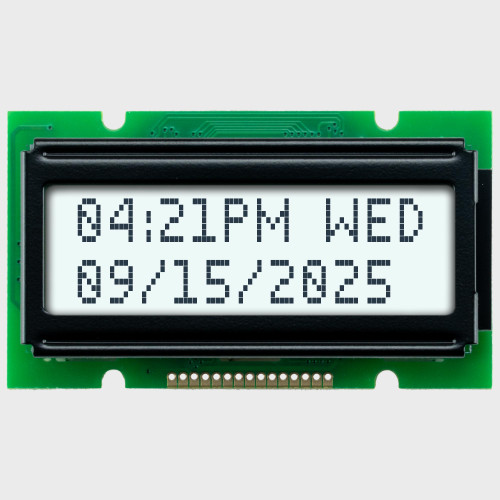 Front view of a 12x2 character LCD with a white backlit screen showing time and date information in dark text.