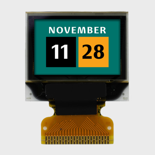 Front view of a 96x64 pixel graphic OLED display with an attached 23-pin FFC cable showing a full-color calendar graphic on a green background.