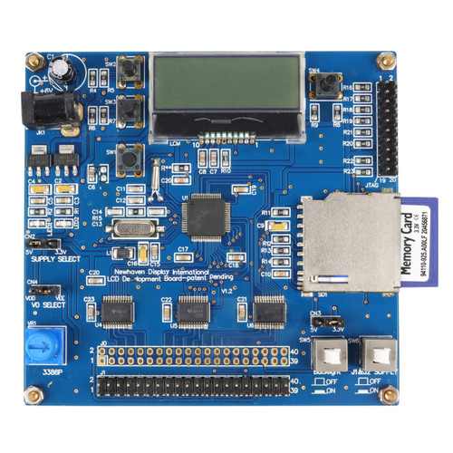 The front of a blue circuit board with many components and connections, including an SD card reader with a card inserted.