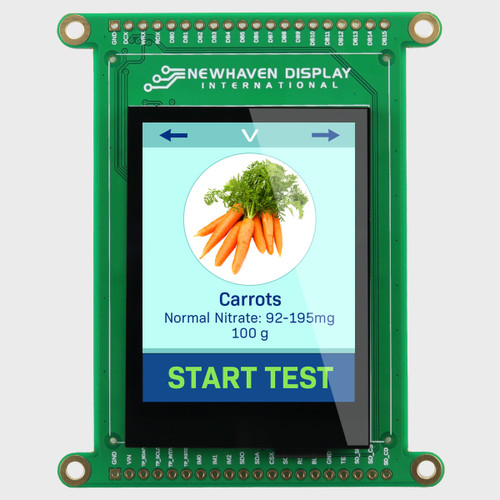 Front view of a green circuit board with an integrated 2.4-inch IPS TFT display showing a testing interface with carrots in a white circle with a light blue background and a dark blue start button.