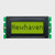 Vista frontal de una pantalla LCD STN+ amarillo-verde de 8x1 caracteres apagada que muestra la palabra «Newhaven» en texto oscuro.