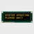 Front view of a 16x2 character OLED display module on a green PCB showing illuminated yellow text on a black background.