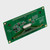 A green PCB for a graphic OLED display module showcasing its 1x20 thru hole connection points and various other components angled with the left side closer to the viewer to showcase its width.