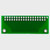 Il retro di un circuito stampato verde con 37 punti di connessione a foro passante.
