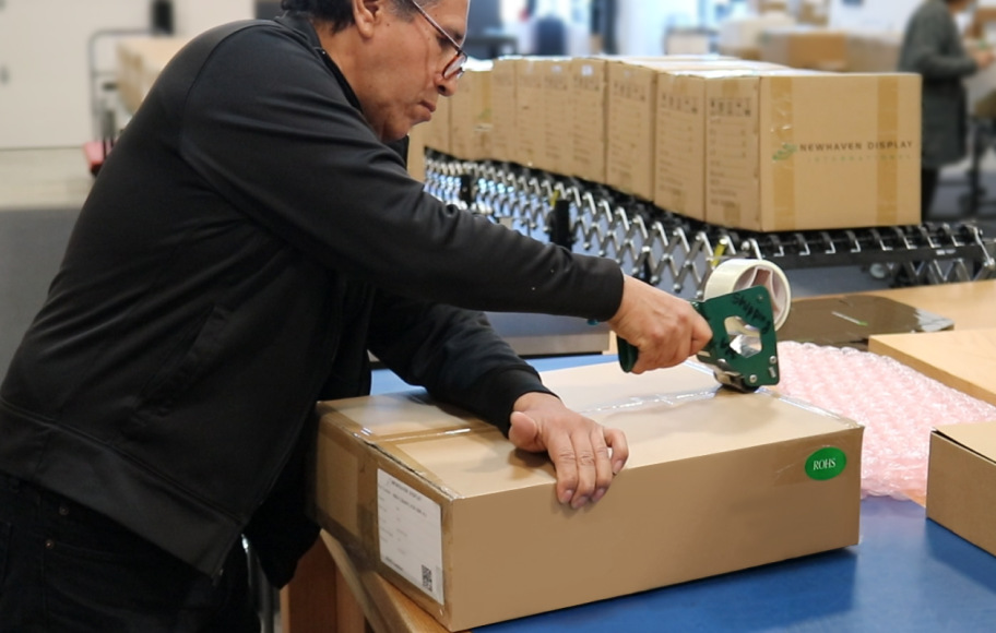 Warehouse employee packing electronic displays