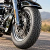 Dunlop D404-style front motorcycle tire mounted on a cruiser motorcycle with a spoked wheel
