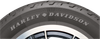 Three-quarter angle studio view of the Dunlop D401 130/90B16 rear blackwall cruiser tire displaying its deep computer-optimized center grooves against a plain white backdrop.