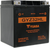 Yuasa GYZ32HL YUAM732GHL factory activated maintenance-free heavy duty AGM battery showing its rugged black poly-propylene casing with a solid black top layout, featuring molded copper-alloy terminal inserts with left-side negative and right-side positive orientation, isolated against a solid white studio background.