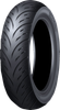 A high-resolution studio product photograph of the Dunlop Scootsmart 2 rear scooter and commuter tire in 150/70-13 64S sizing, isolated against a solid white background. The tire is shown standing upright at a three-quarter perspective to showcase its high-silica, all-weather tread geometry. Engineered for maxi-scooters and urban commuters, the tread pattern features long, sweeping directional grooves designed for optimal water evacuation, enhanced carcass flexibility for mileage and comfort, and clean embossed "SCOOTSMART 2" branding along its matte black rubber sidewall.