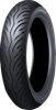 A high-resolution studio product photograph of the Dunlop Scootsmart 2 front scooter and touring motorcycle tire in 120/70-15 56S sizing, isolated against a seamless white background. The tire is positioned upright at a three-quarter angle to highlight its progressive tread pattern. Designed for maxi-scooters and commuter bikes, the tread features long, sweeping directional grooves designed for optimal water evacuation in wet weather, balanced tread block rigidity for enhanced stability, and crisp embossed "SCOOTSMART 2" sidewall branding along its matte black rubber casing.