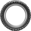 A professional studio product photograph of the Dunlop D605 dual-sport rear motorcycle tire in 4.60-18 63P sizing, isolated against a seamless, solid white background. The tire is standing upright at a three-quarter perspective to showcase its versatile 50/50 street-and-trail tread design. The layout features block-style center tread lugs engineered for smooth highway tracking and tread longevity, flanked by aggressive, self-cleaning shoulder knobs for off-road cornering traction on gravel, dirt, and light trail terrain, with clean embossed sidewall branding on its matte black rubber casing.