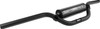 A high-resolution studio product photograph of the ProTaper Mini Aluminum Handlebar in a sleek matte black finish, set against a clean white background. Displayed from a front perspective angle, the handlebar is precision-manufactured from high-strength 2000-series T6 aluminum with a standard 7/8-inch outer diameter. Tailored specifically for youth riders and mini-motocross applications, it features scaled-down bend dimensions for enhanced ergonomics on smaller machines, complete with a cold-forged aluminum crossbar, stainless steel hardware, knurled clutch-side tubing to prevent grip rotation, and a high-density crossbar pad featuring signature ProTaper branding.