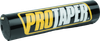 A high-resolution studio product photograph of a ProTaper Molded 10-inch Round Bar Pad in Black, set against a clean white background. Displayed at a front-three-quarter angle, the full-size 10-inch cylindrical high-density molded foam pad features a glossy black vinyl cover, bold yellow and white "PROTAPER" block logo graphics enclosed in a yellow outline across the front, and durable black molded end caps designed for full-size crossbar handlebars.