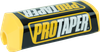 A high-resolution studio product photograph of a ProTaper 2.0 Square Bar Pad in Yellow/Black, set against a clean white background. Displayed at a front-three-quarter angle, the high-density molded closed-cell foam pad features a vibrant yellow vinyl cover with bold black "PROTAPER" block logo graphics printed across the front, black side accents, and a streamlined square profile with cutouts designed specifically for oversized 1-1/8" un-braced handlebars.