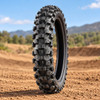 ProTaper MXT 04 rear motocross tire displayed upright on a dirt track