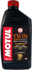 A high-resolution studio product photograph of a 1 U.S. quart (946 ml) bottle of Motul Twin 100% Synthetic 20W-50 motor oil, set against a clean white background. Standing upright at a front-facing angle, the sleek black plastic bottle features side grip contours, an embossed Motul logo near the neck, and a red twist-off cap. The distinct front label displays a dark panel featuring a detailed V-Twin engine graphic alongside the vertical white "MOTUL" logo set on a red banner, paired with bold orange and white "TWIN", "20W-50", "100% SYNTHETIC", and "ESTER" callouts. Specially formulated with 100% synthetic Ester technology for large-displacement V-Twin engines, it meets API SN and JASO MA2 standards to deliver superior oil film strength, extreme high-temperature stability, smooth wet-clutch operation, and anti-wear protection for air-cooled or liquid-cooled cruiser motorcycles.