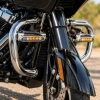 Custom Dynamics chrome engine guard LED lights mounted on a black touring motorcycle