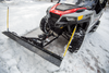 Front view of a UTV with an Open Trail straight plow blade and yellow markers in snow