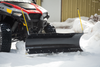 Open Trail plow blade on a UTV pushing a snow pile beside a garage
