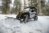 UTV plowing snow with an Open Trail straight blade near pine trees