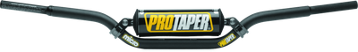 A high-resolution studio product photograph of the ProTaper Micro Schoolboy Low Handlebar, set against a clean white background. Displayed from a front-facing studio angle, the handlebar is precision-manufactured from high-strength 2000-series T6 aluminum alloy with a cold-forged crossbar. Specifically tailored for youth riders transition-sizing on 50cc to 85cc mini motorcycles, it features ProTaper's specialized abrupt-taper design with reduced-diameter grip ends to comfortably accommodate smaller hands, while maintaining a standard 7/8-inch clamping area. The assembly includes knurled clutch-side tubing to prevent grip rotation, laser-etched alignment grid markings, and a high-density crossbar pad with signature ProTaper branding.