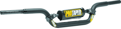 A high-resolution studio product photograph of the ProTaper Micro KTM 50 Handlebar (Part Number 025043) in a black anodized finish, set against a clean white background. Displayed from a front-facing studio angle, the handlebar is precision-manufactured from high-strength 2000-series T6 aluminum alloy with a cold-forged crossbar. Specifically tailored for youth riders on KTM 50cc models, it features ProTaper's specialized abrupt-taper design that narrows at the handhold sections to fit small hands, while maintaining a standard 7/8-inch clamp and control area. The assembly includes knurled clutch-side tubing for maximum grip adhesion, laser-etched alignment markings, and a high-density crossbar pad with signature ProTaper branding.