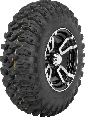 A high-resolution studio product photograph of a QuadBoss QBT446 Radial Utility ATV/UTV tire in size 26x11R12, set against a clean white background. Displayed at a front-three-quarter angle, the heavy-duty rear radial all-terrain utility tire features a non-directional, multi-surface tread design with tight center lugs for a smooth ride on hardpack and wrapped shoulder lugs for aggressive side-bite and cornering control. Constructed with an 8-ply rated radial carcass, the durable black rubber casing displays crisp embossed sidewall text including "QUADBOSS", "QBT446", and "26x11R12".