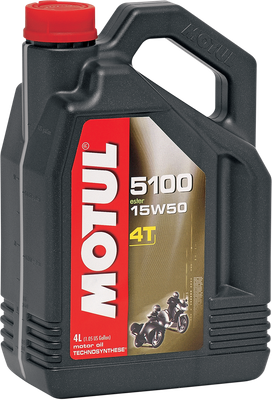 A high-resolution studio product photograph of a 4-liter container of Motul 5100 4T Technosynthese engine oil in 15W-50 viscosity, set against a clean white background. Standing upright at a front-facing angle, the heavy-duty matte black plastic jug features an ergonomic integrated top handle, side grip ridges, and a red twist-off cap. The distinct front label displays a dark panel featuring a motorcycle outline graphic alongside bright green and white "5100", "15W-50", "TECHNOSYNTHESE®", "ESTER", and "4T MOTOR OIL" callouts above the white "MOTUL" logo set on a bold red banner.