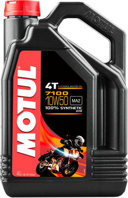 A high-resolution studio product photograph of a bulk 4-liter container of Motul 7100 4T 100% Synthetic engine oil in 10W-50 viscosity, set against a clean white background. Standing upright at a front-facing angle, the heavy-duty matte black plastic jug features an ergonomic integrated top handle, side grip ridges, and a red twist-off cap. The distinct front label displays a dark panel featuring an adventure motorcycle graphic alongside the white "MOTUL" logo set on a bold red banner, paired with bright orange and white "7100", "10W-50", "100% SYNTHETIC", and "ESTER" callouts.