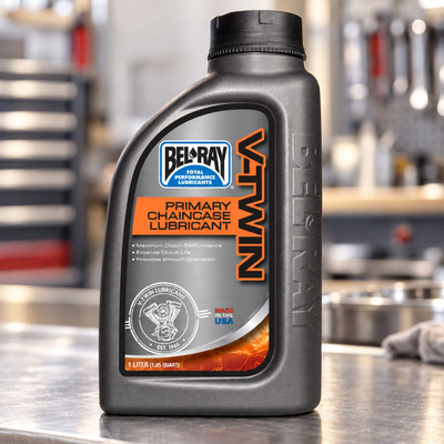 Bel-Ray Primary Chaincase Lubricant 1-liter bottle in a motorcycle service workshop