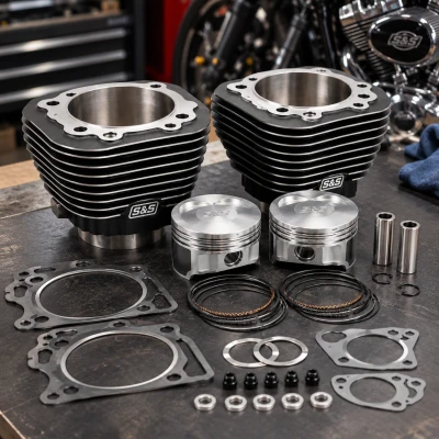 S&S Cycle 3-5/8-inch Big Bore Cylinder and Piston Kit 91-9001 displayed on a motorcycle workshop bench