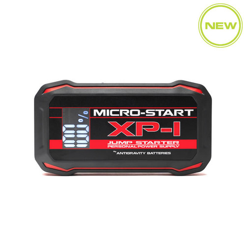 Front view photo of the ultra-compact tactical black Antigravity Micro-Start XP-1-G2 power pack showcasing its lit digital status monitor screen, integrated LED flashlight lens, and side port configurations flat on a white background.