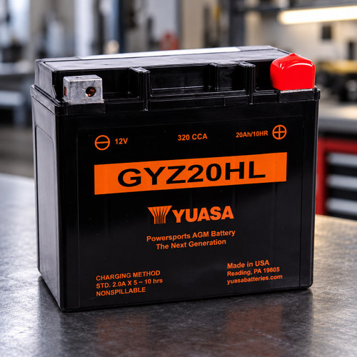 Yuasa GYZ20HL maintenance-free AGM battery displayed in a professional motorcycle workshop