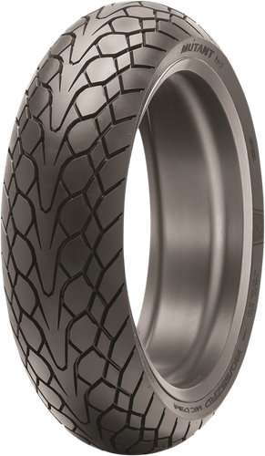 A high-resolution studio product photograph of the Dunlop Mutant rear crossover motorcycle tire in 180/55ZR17 73(W) sizing, isolated against a bright white background. Mounted on a bronze multi-spoke wheel, the tire is positioned vertically at a three-quarter perspective to showcase its aggressive, all-weather crossover tread design. The tread features deep directional siping, wet-weather evacuating grooves, and a distinctive multi-block pattern engineered for sport-touring, adventure, and crossover performance, accompanied by raised branding and tire sizing specifications clearly embossed on the matte black rubber sidewall.