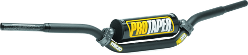 A high-resolution studio product photograph of the ProTaper Micro Schoolboy Low Handlebar, set against a clean white background. Displayed from a front-facing studio angle, the handlebar is precision-manufactured from high-strength 2000-series T6 aluminum alloy with a cold-forged crossbar. Specifically tailored for youth riders transition-sizing on 50cc to 85cc mini motorcycles, it features ProTaper's specialized abrupt-taper design with reduced-diameter grip ends to comfortably accommodate smaller hands, while maintaining a standard 7/8-inch clamping area. The assembly includes knurled clutch-side tubing to prevent grip rotation, laser-etched alignment grid markings, and a high-density crossbar pad with signature ProTaper branding.