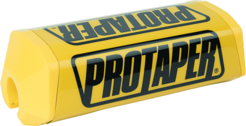 A high-resolution studio product photograph of a ProTaper 2.0 Square Bar Pad in Race Yellow, set against a clean white background. Displayed at a front-three-quarter angle, the high-density molded closed-cell foam pad features a bright yellow vinyl cover, bold black "PROTAPER" block logo graphics printed across the front, and a streamlined square profile with cutouts designed specifically for oversized 1-1/8" un-braced handlebars.