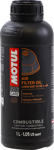 A high-resolution studio product photograph of a 1-liter bottle of Motul MC CARE A3 Air Filter Oil, set against a clean white background. Standing upright at a front-facing angle, the cylindrical black plastic bottle features a wide-mouth dark screw cap designed for easy pouring into filter tubs. The front label features the bold white "MOTUL" logo vertically set in a red banner alongside white and yellow "MC CARE", "A3", and "AIR FILTER OIL" typography, paired with an illustration of a foam filter element. Specially formulated for foam air filters on off-road, dirt, and ATV motorcycles, its blue-tinted, high-tack formula traps sand, dust, and mud while resisting water ingress to ensure maximum engine intake protection.