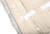 Hook and loop fasteners on back of sheepskin stroller liner for easy installation and removal.