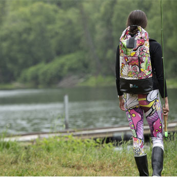 A lady in Gishe Wear gear looking at the water 