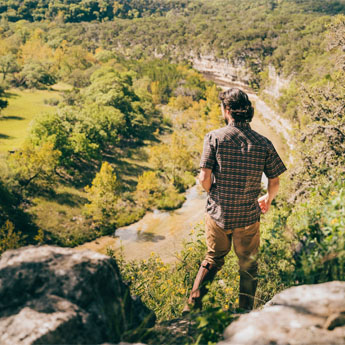 Man overlooking the Hill Country in Howler Bros pants